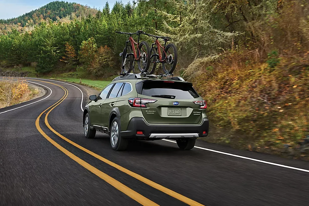 Subaru Outback driving on a road