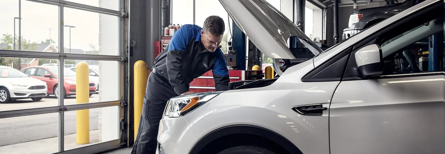 Ford Service Tech working on a vehicle