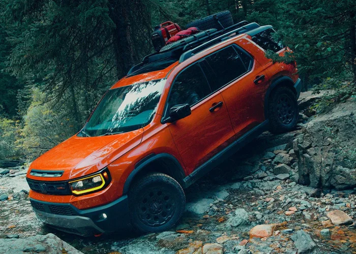 Honda Passport driving over rocky terrain