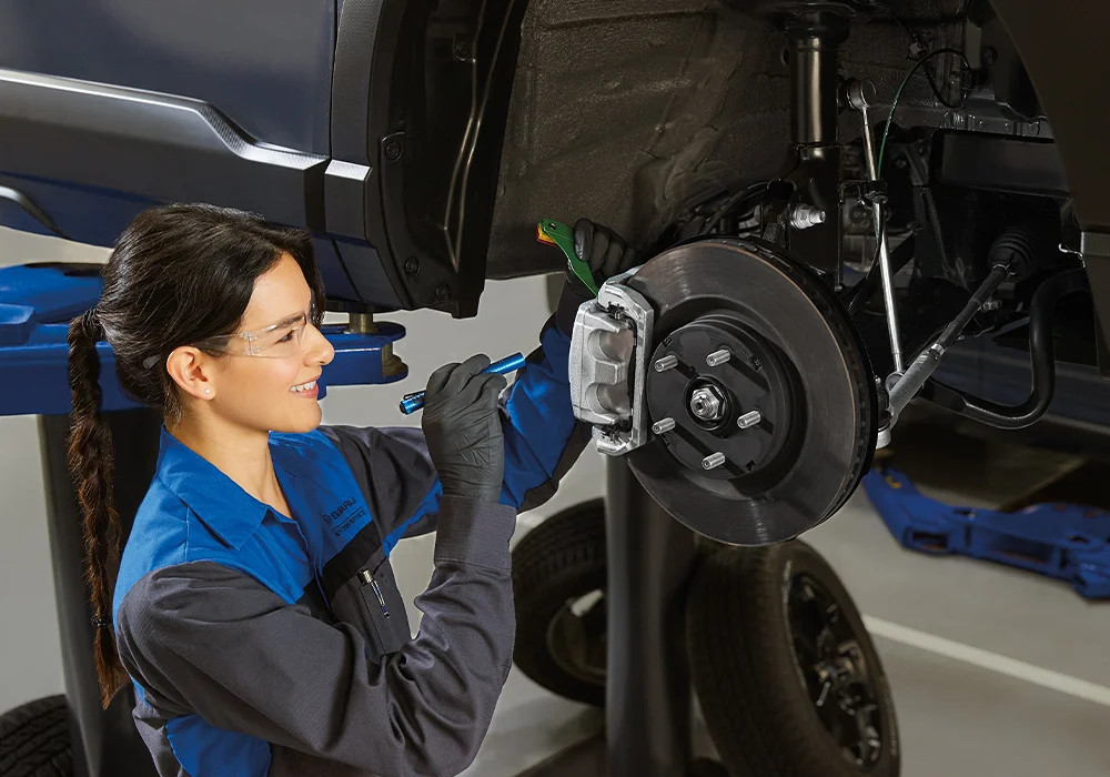 Subaru Service Subaru Tech working on a car