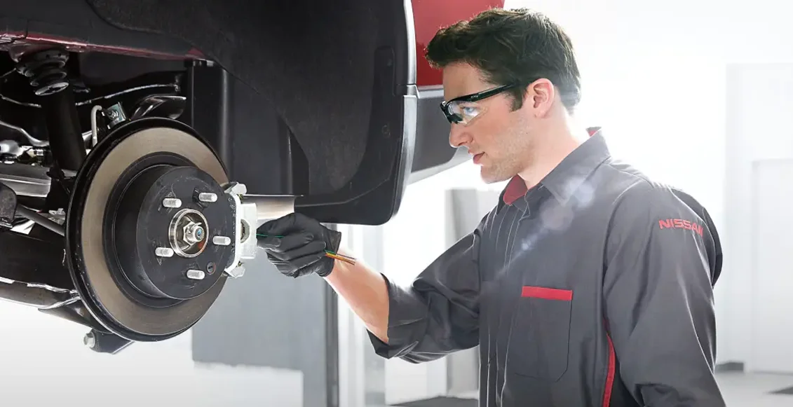 Technician Checking Brakes