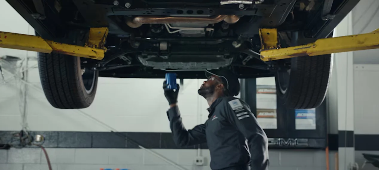 GMC service tech working on a car