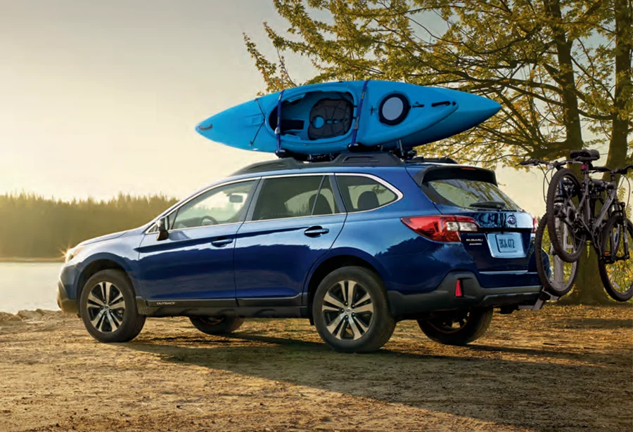 Subaru Outback parked by a lake