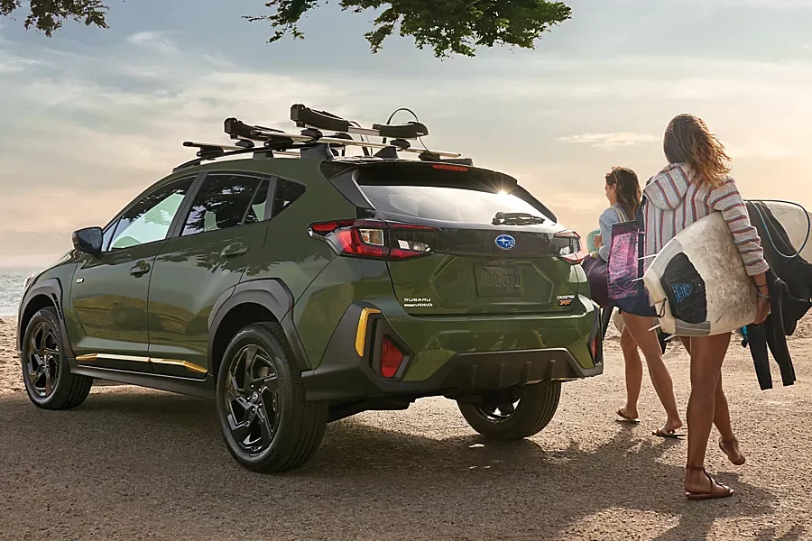 Girls with surf boards near a Subaru Crosstrek