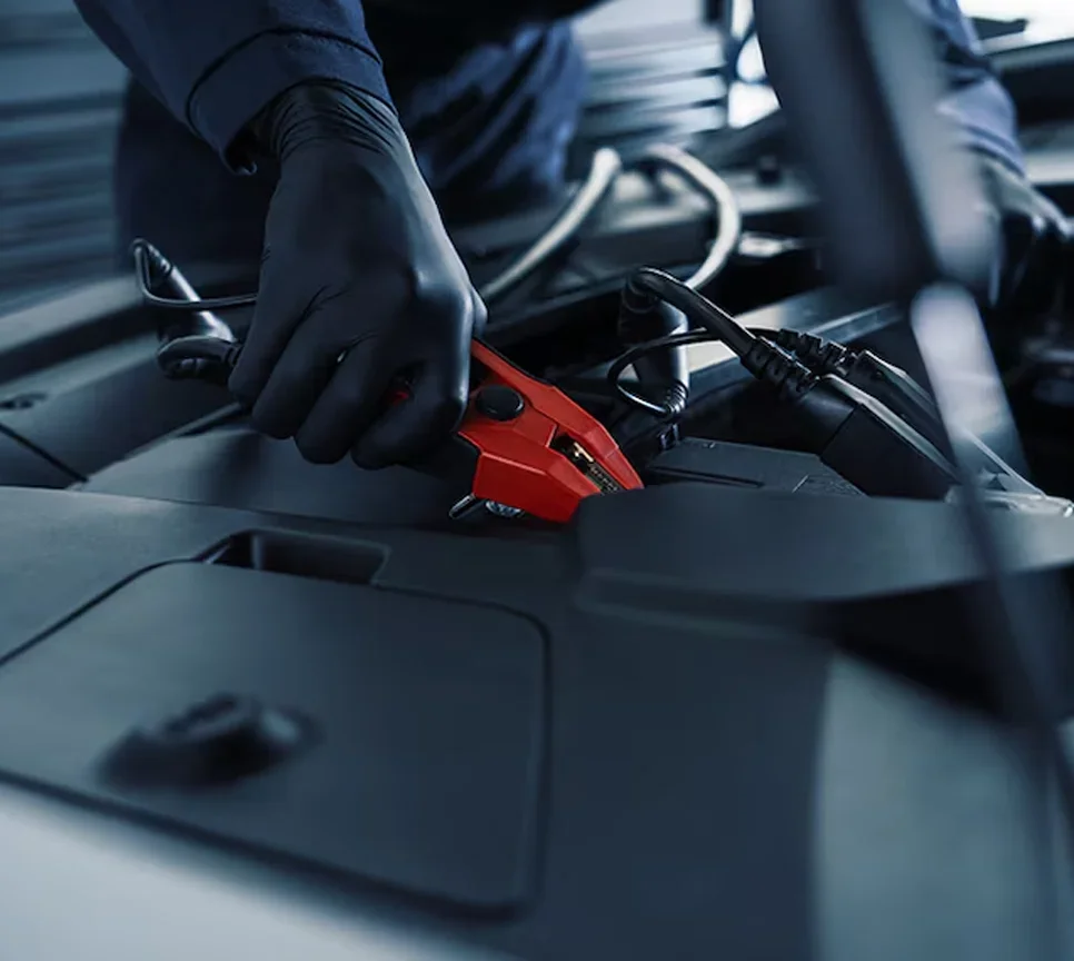 Cadillac service technician hooking up battery