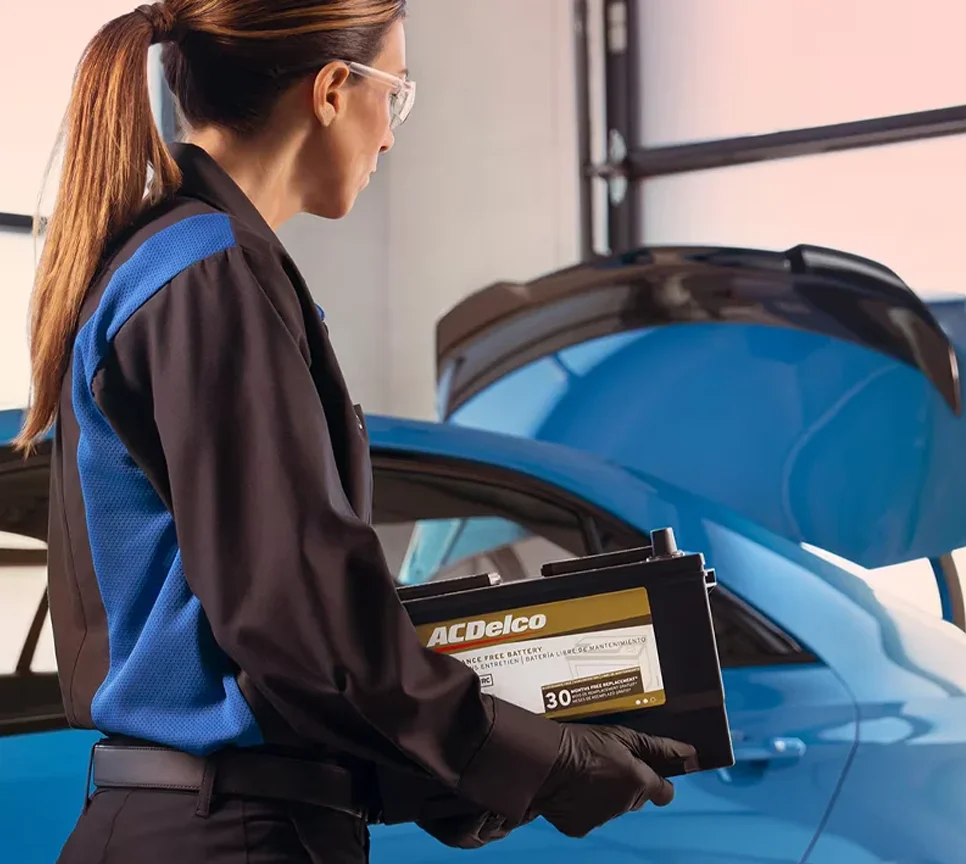 Cadillac service technician hooking up battery