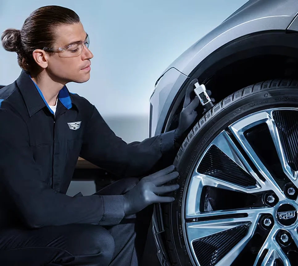 Cadillac service technician Checking Tire
