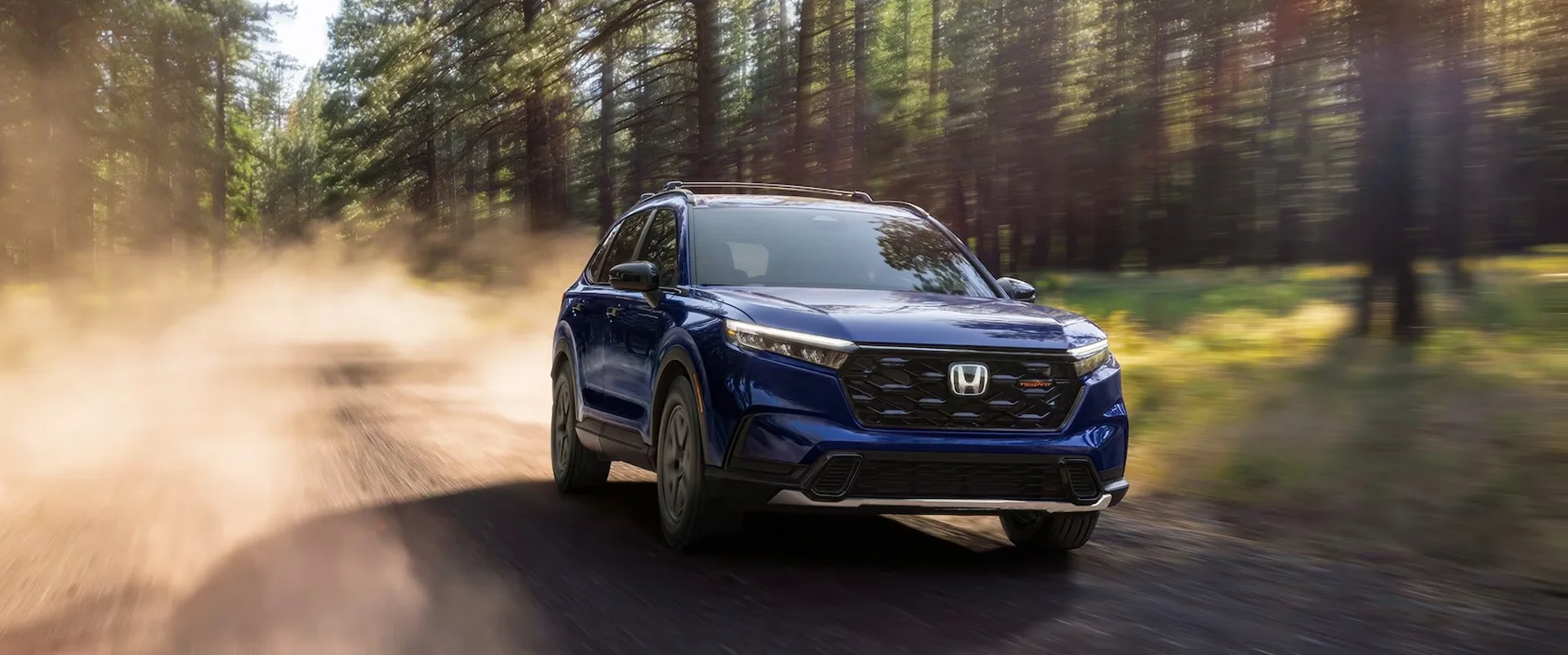 2026 Honda CR-V drivng through a wooded Road