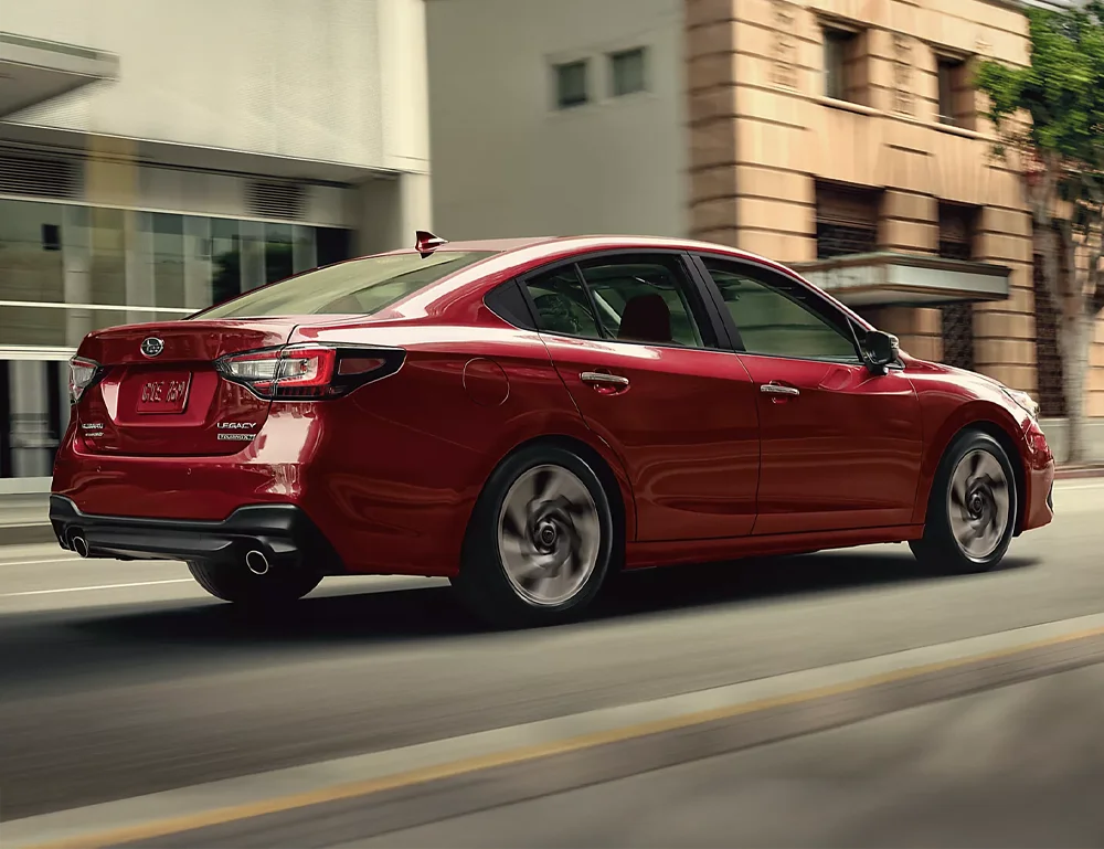 Subaru Legacy driving down road