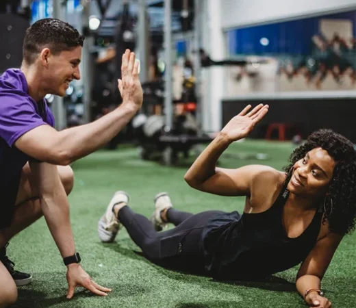 Personal Trainer Working With Client