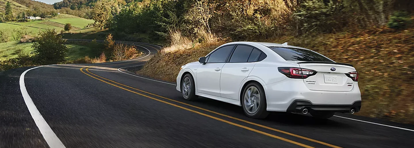 Subaru Legacy driving down the street