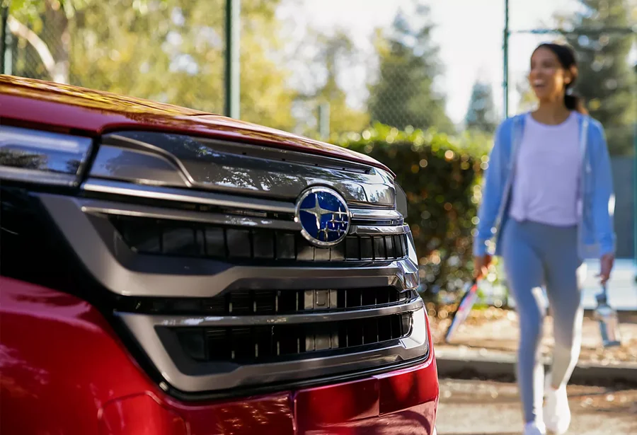 Woman Walking Up to Subaru
