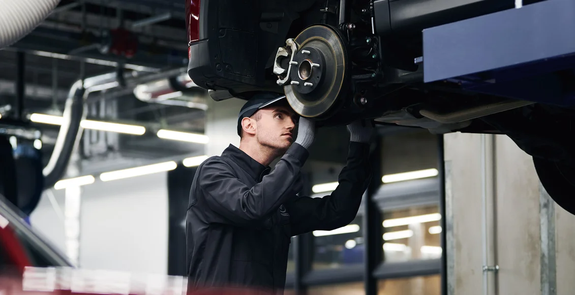 Mazda Tech working on a car
