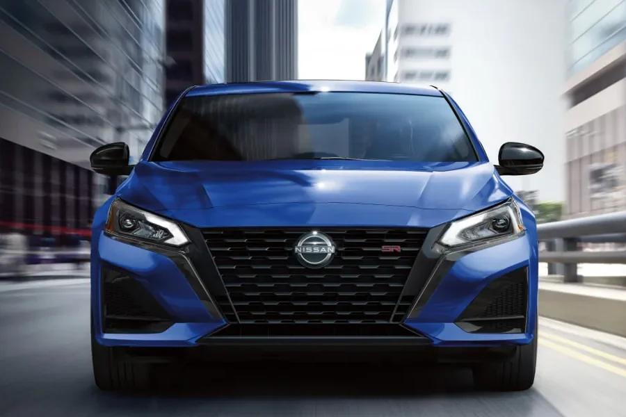 2025 Nissan Altima driving down a city street