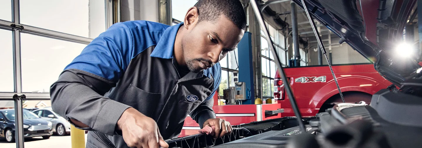 Ford Service Tech working under a hood