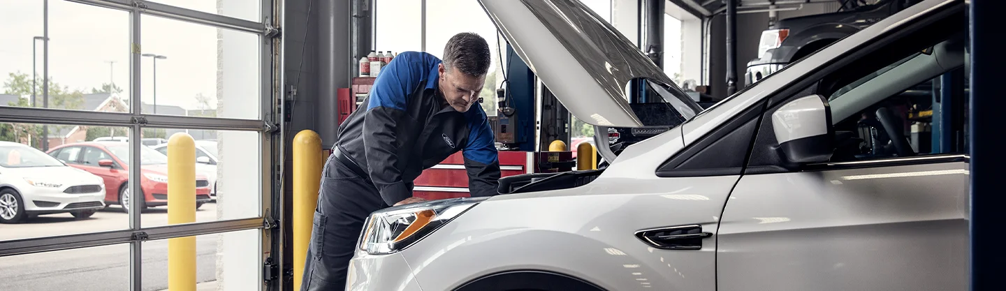 Ford Service Tech working on a car