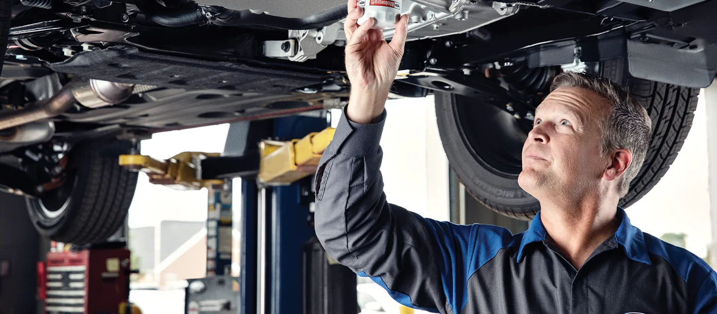 Ford Service Tech working under a car