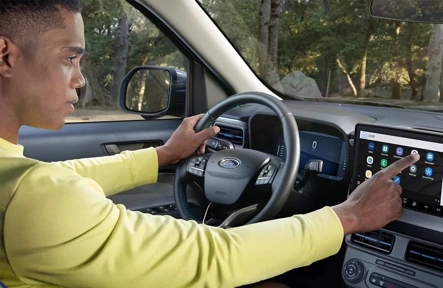 Man in the drivers seat of a Ford Maverick