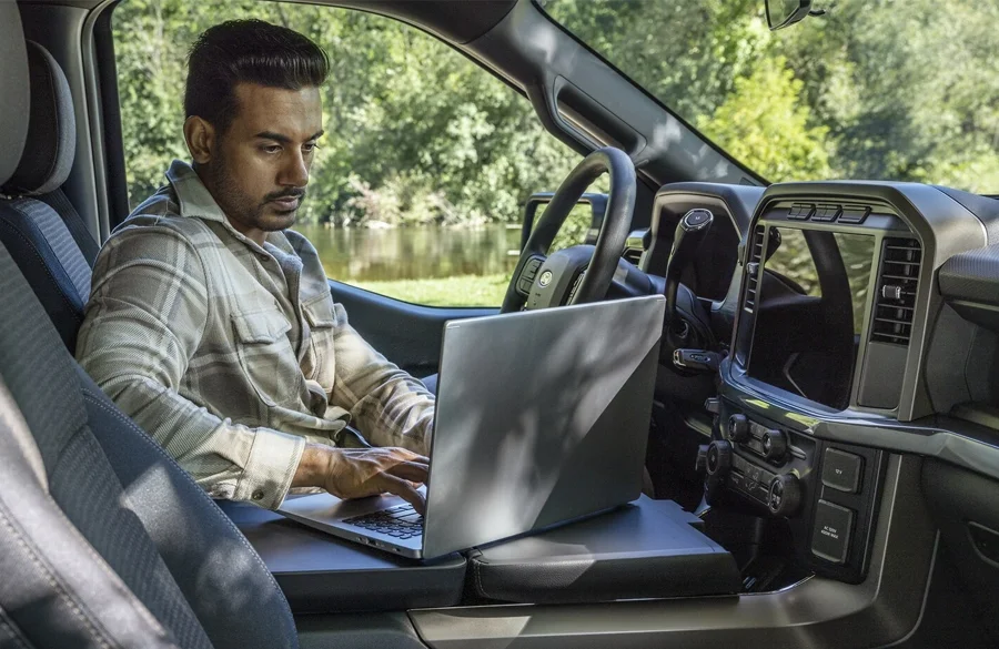 Man on a laptop in a Ford F-150
