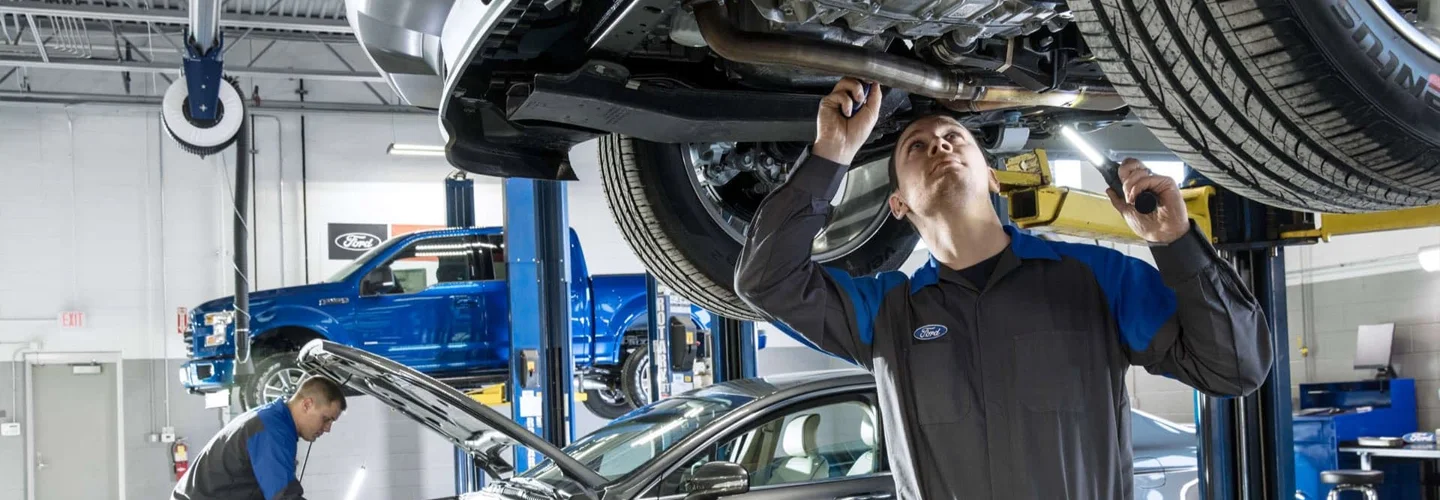 Ford Service Tech working on a vehicle