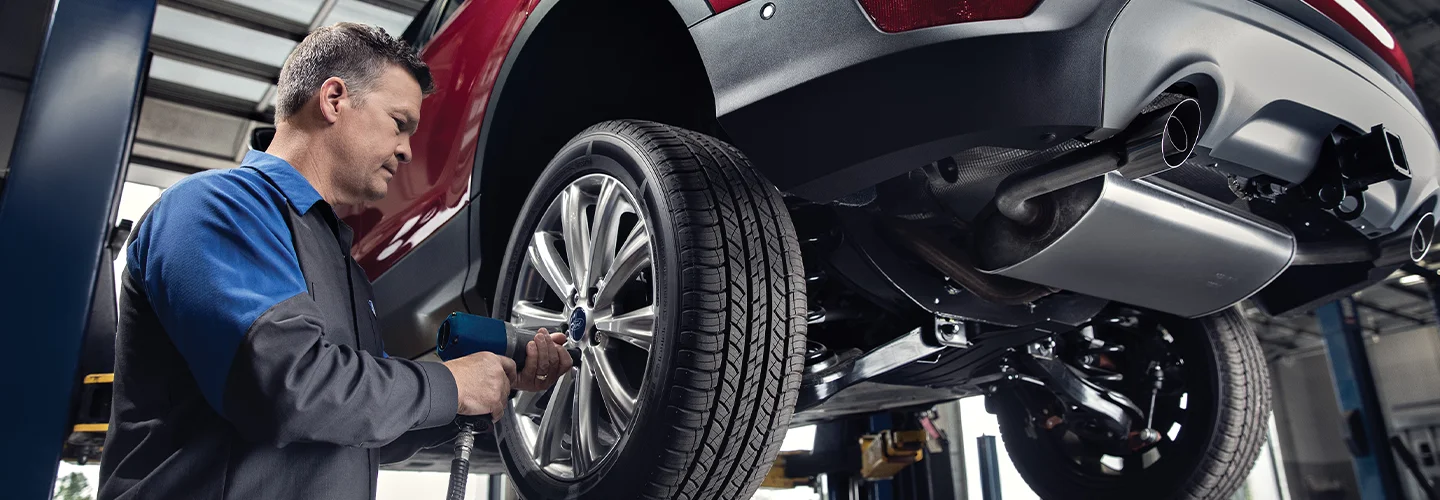 Ford Service Tech working on a vehicle
