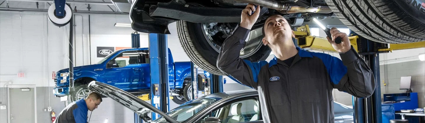 Ford Service Tech working under a car