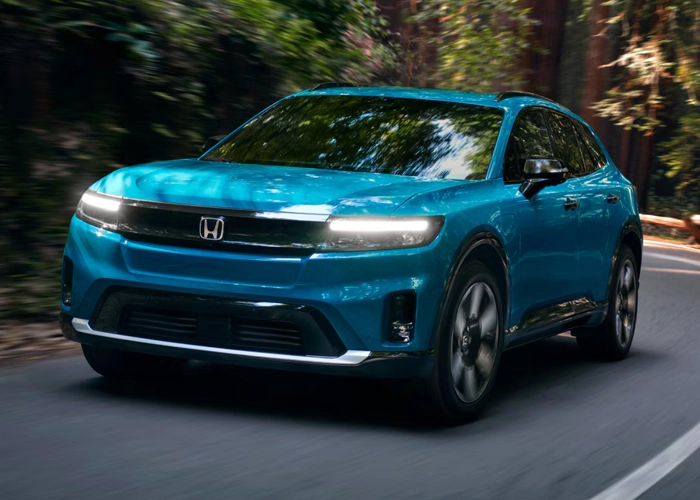 2026 Honda Prologue driving on a wooded road