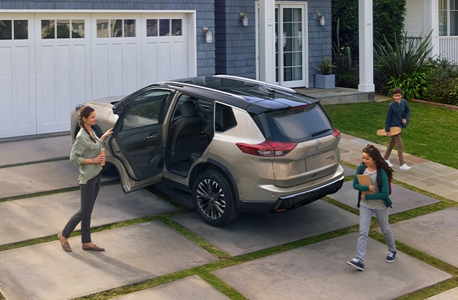 Family getting into a Nissan Rogue