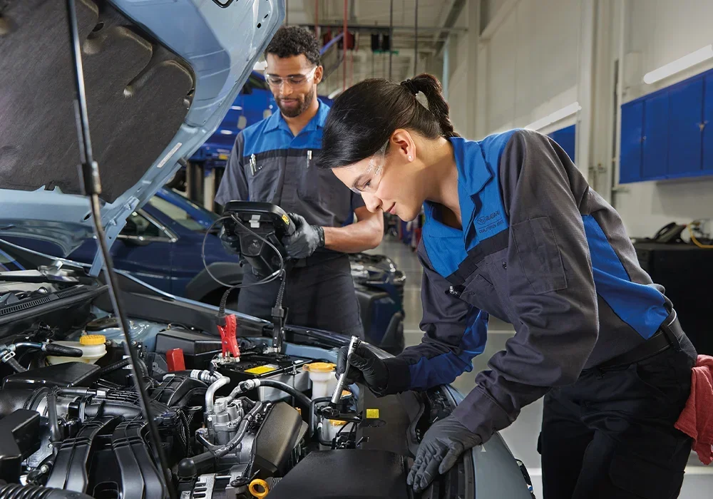 Subaru Techs Looking at Car