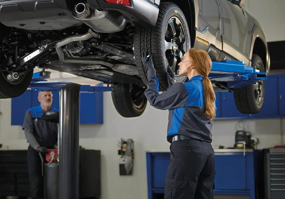 Subaru Tech working under a car