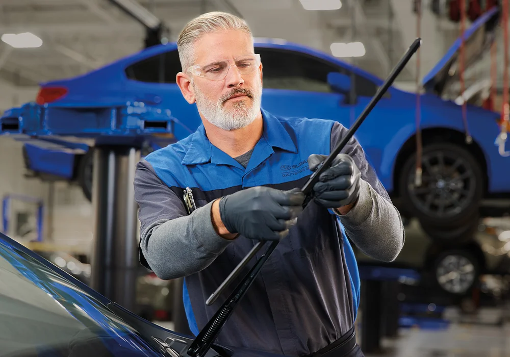 Subaru Tech working on a car