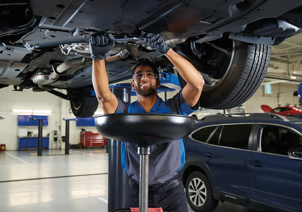 Subaru Tech working under a vehicle
