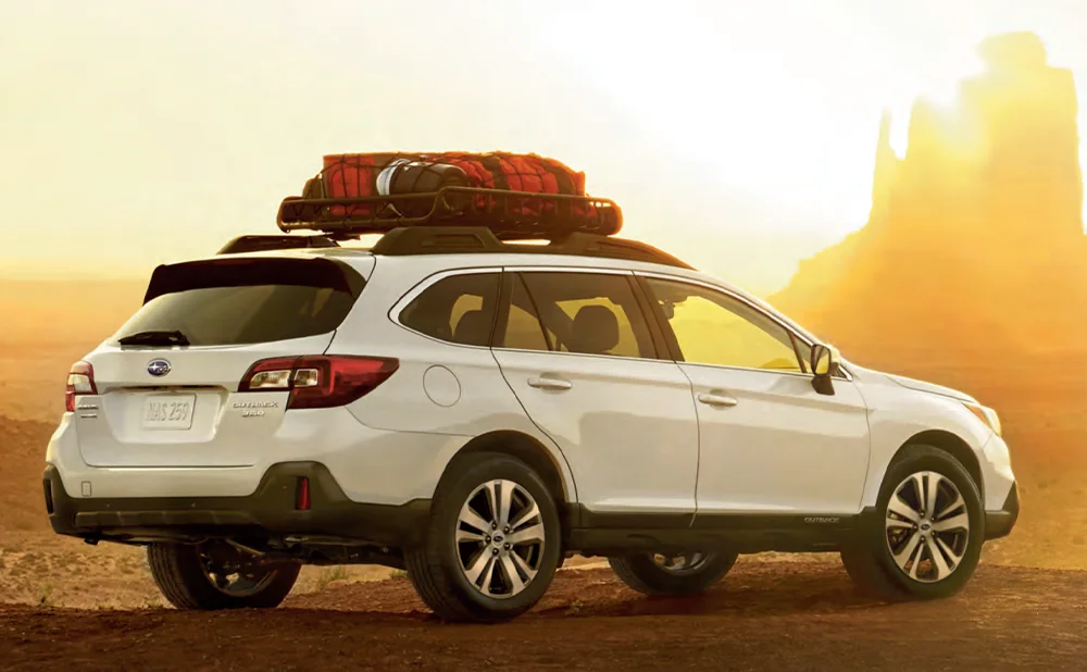 Subaru Outback parked on a dirt road