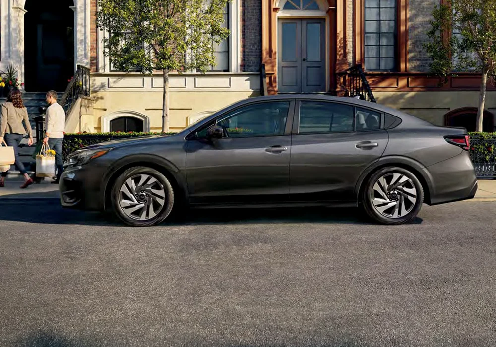 Subaru Legacy parked by a sidewalk